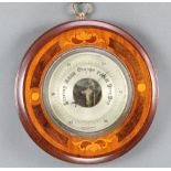 An aneroid barometer with silvered dial contained in a circular inlaid mahogany case 9"