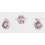 A silver and cubic zirconia ring and earring set with purple stones