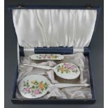 A cased 3 piece (ex 4) silver plated guilloche enamel brush set