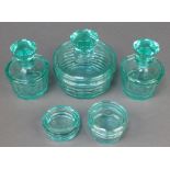 An Art Deco cyan glass dressing table set with powder bowl and lid, 2 scent bottles and stopper, a