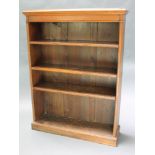 A Victorian oak open bookcase fitted adjustable shelves raised on a platform base, 48" x 36"w x 11"d