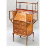 An Art Nouveau mahogany bureau with railed back, the fall front flanked by a pair of recesses the