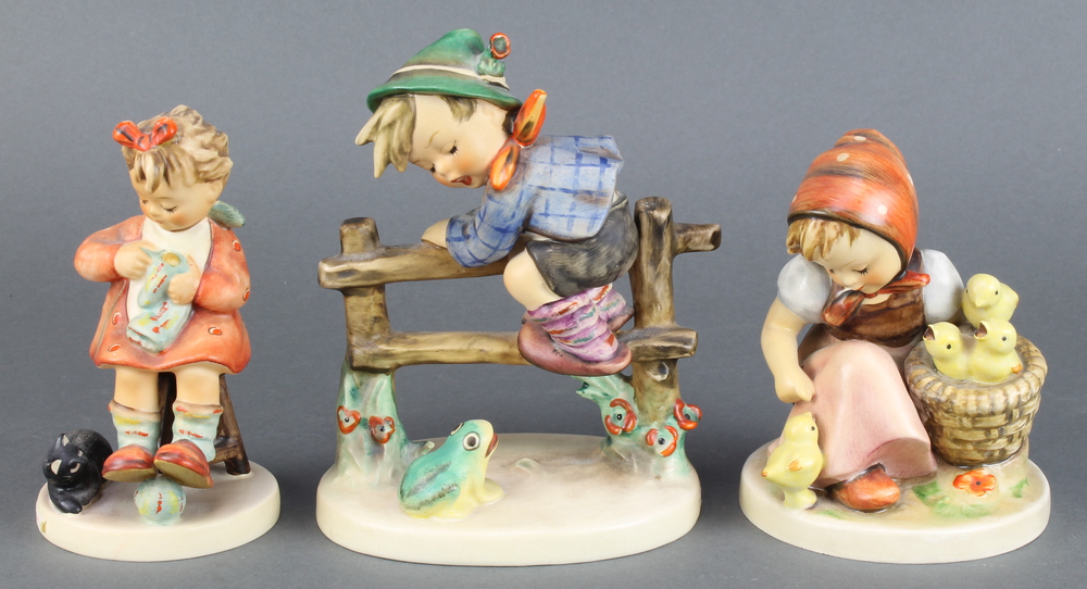 A Hummel figure - Chick Girl 57/1 4 1/2", do. boy on a fence 5" and a girl with a kitten 4"