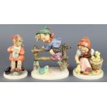 A Hummel figure - Chick Girl 57/1 4 1/2", do. boy on a fence 5" and a girl with a kitten 4"