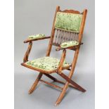 A Victorian beech framed folding campaign armchair with bobbin turned decoration