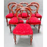 A set of 6 Victorian mahogany balloon back dining chairs, the seats of serpentine outline, raised on