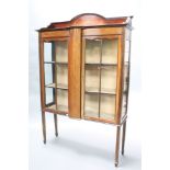 An Edwardian inlaid mahogany display cabinet with raised back, fitted shelves enclosed by astragal