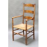A pierced elm ladderback carver chair with woven rush seat