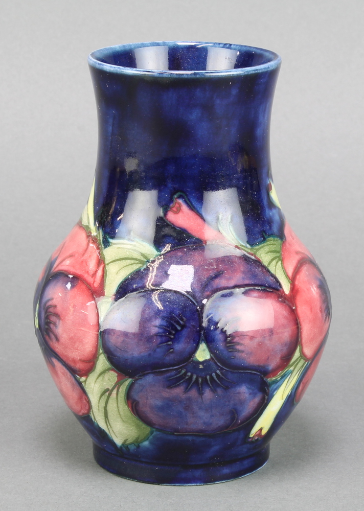 A Moorcroft blue ground baluster vase decorated with pansies, impressed and painted marks 5" There