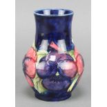 A Moorcroft blue ground baluster vase decorated with pansies, impressed and painted marks 5" There