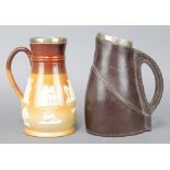 A Doulton Lambeth leatherwork jug with silver collar London 1891 9" and a stoneware jug with