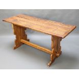 A rustic oak refectory dining table, the top formed from 3 planks and raised on standard end