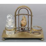 A rectangular gilt metal 2 bottle stand, the centre decorated an Austrian cold painted bronze figure