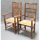 A pair of elm Lancashire ladder back carver chairs with woven rush seats