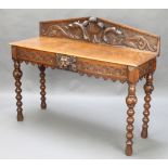 A Victorian carved oak hall table, the raised back with Prince of Wales feathers, fitted 2 short