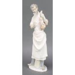 A Lladro figure of an Obstetrician holding a baby, 14"