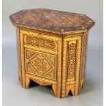 A Moorish style octagonal inlaid hardwood work table with hinged lid, the base fitted a cupboard