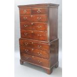 A George III mahogany chest on chest, the upper section with moulded cornice and fluted canted