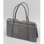 A lady's black "lizard skin" handbag with gilt metal mounts 8" x 11" x 3"