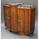 An Art Deco German carved oak sideboard with 3 section black veined marble top above a triple