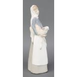 A Lladro figure of a young lady carrying a lamb 11"