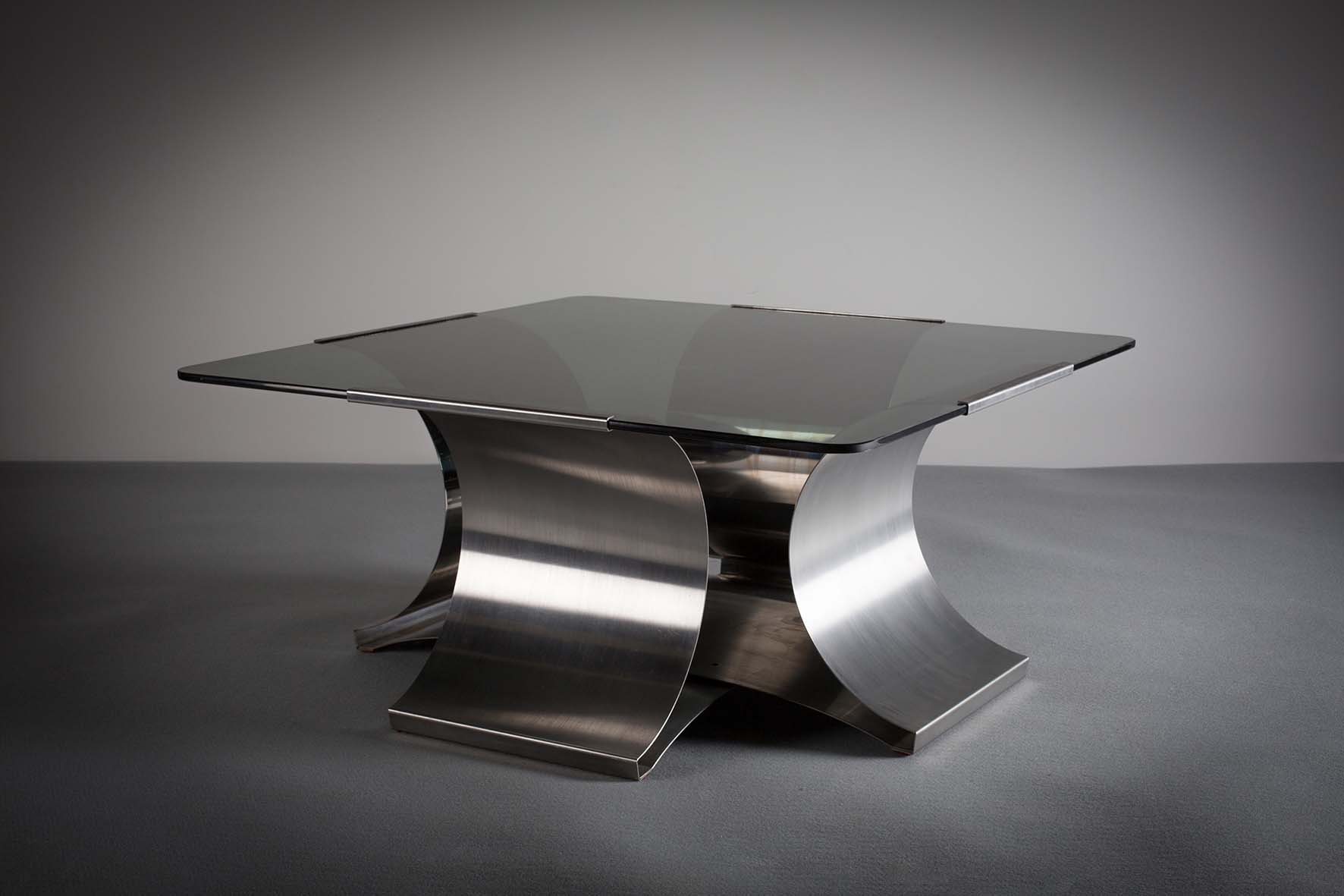 A CHROME COFFEE TABLE, ITALIAN, 1960s, with smoked glass top on a shaped base, 89cm square