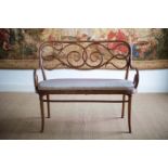 A BENTWOOD CHAIR BACK SETTEE by Thonet, bearing label. 113cm x 98cm high x 54cm deep.