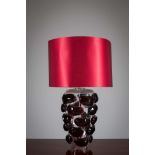 A GLASS TABLE LAMP, CONTEMORARY, the molded glass base, with red shade, 80cm (h)