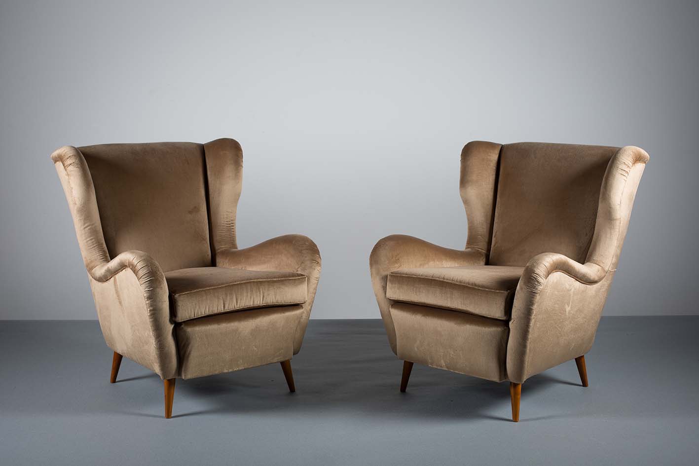 A PAIR OF ITALIAN WING BACK CHAIRS, 1960s, with shaped arms, on tapering legs