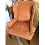 AN UPHOLSTERED WING BACK ARM CHAIR, in Georgian Style, on square legs