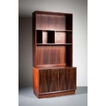 A ROSEWOOD UPRIGHT BOOKCASE, DANISH, with open shelving, the base with two cupboard doors, 100cm (w)