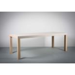 A LIGNE ROSET MILLESIME DINING TABLE, BY CLAUDE BRISSON, CONTEMPORARY, in white oak, on square block