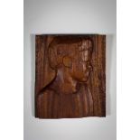 A CARVED WOODEN RELIEF OF A BOY IN PROFILE, 42.5 cm(h) x 36.5cm (w)