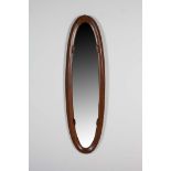 AN OVAL AND ROSEWOOD SHAPED WALL MIRROR, Attributed to Campo e Graffi.. 142cm (h) x 39cm (w)