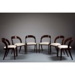 A SET OF SIX DINING CHAIRS, 1970s, with shaped backs above upholstered seats on tapering legs.