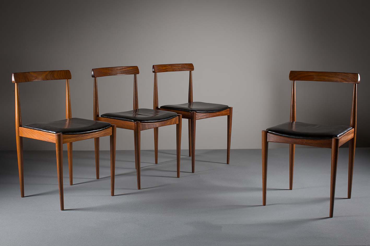 A SET OF FOUR TEAK DINING CHAIRS, DANISH, with plain tablet backs, on tapering legs