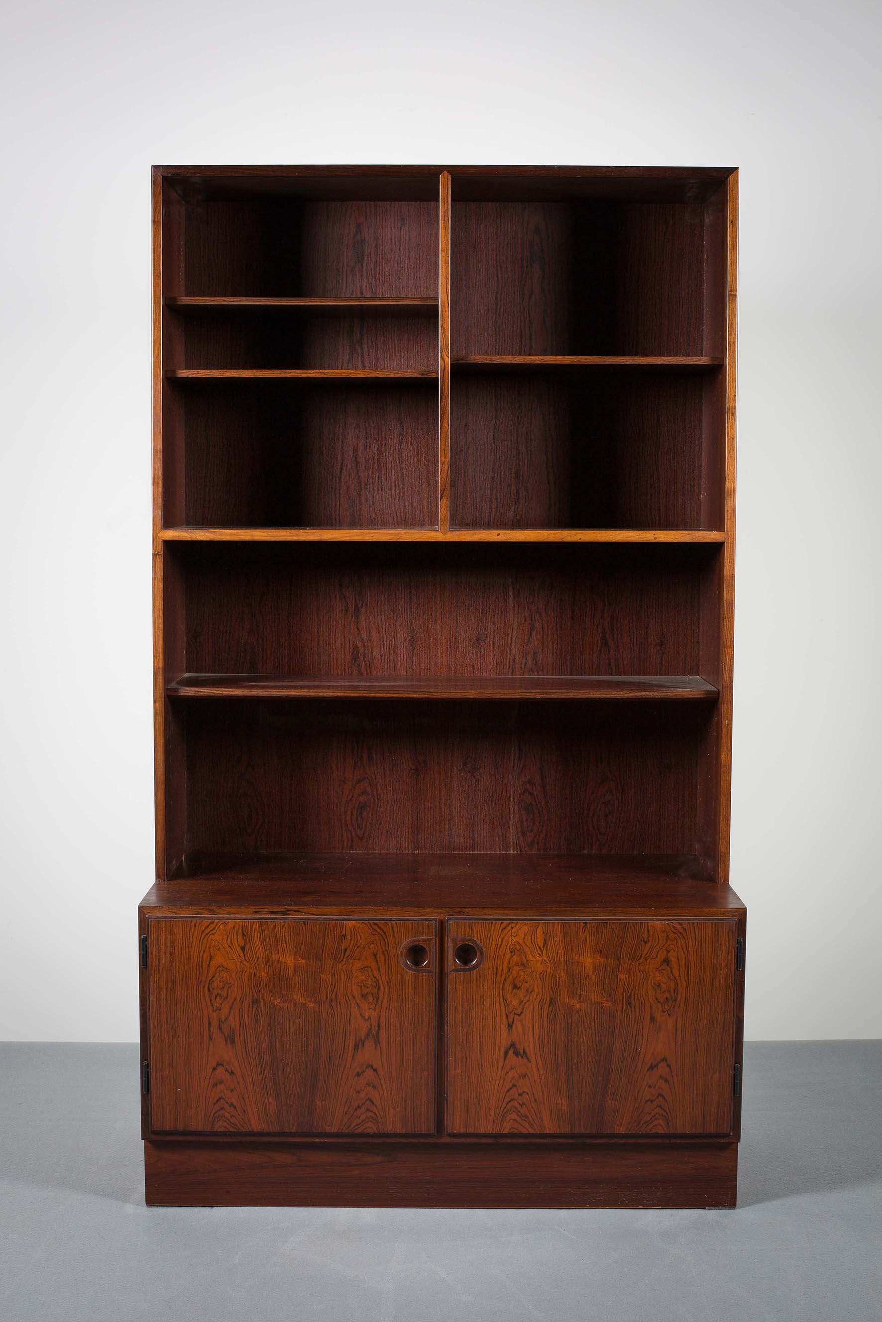 A SINGLE ROSEWOOD BOOKCASE EN SUITE, DANISH, with two cupboard doors