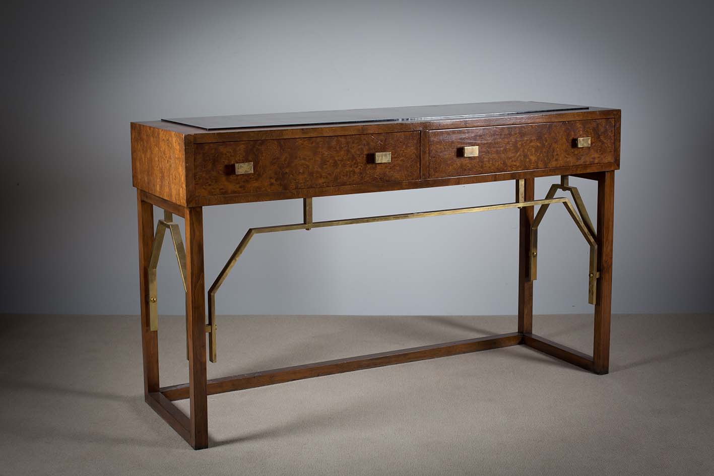 A BURR ELM AND BRASS HALL TABLE, 1970s, with mirrored top above a pair of frieze drawers on