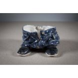 A CERAMIC PLANTER IN THE FORM OF TROUSERS AND SHOES, by Ian Wright, 31 cm (w) x 20cm (h).