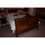 A MAHOGANY DOUBLE BED, on leaf capped ca