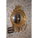 A REGENCY STYLE CONVEX MIRROR, the top s