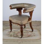 A GEORGE IV OAK AND LEATHER UPHOLSTERTED