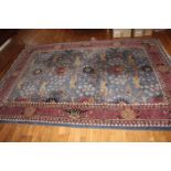 A LARGE FLOOR RUG, ON BLUE GROUND,