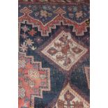 AN ORIENTAL RUG on a blue ground with lo