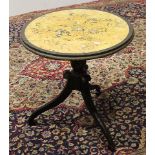 AN EBONISED AND FAUX MARBLE TOPPED TABLE