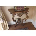 A GILTWOOD CONSOLE TABLE with shaped fru