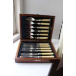 A CASED SET OF SIX FISH KNIVES AND FORKS