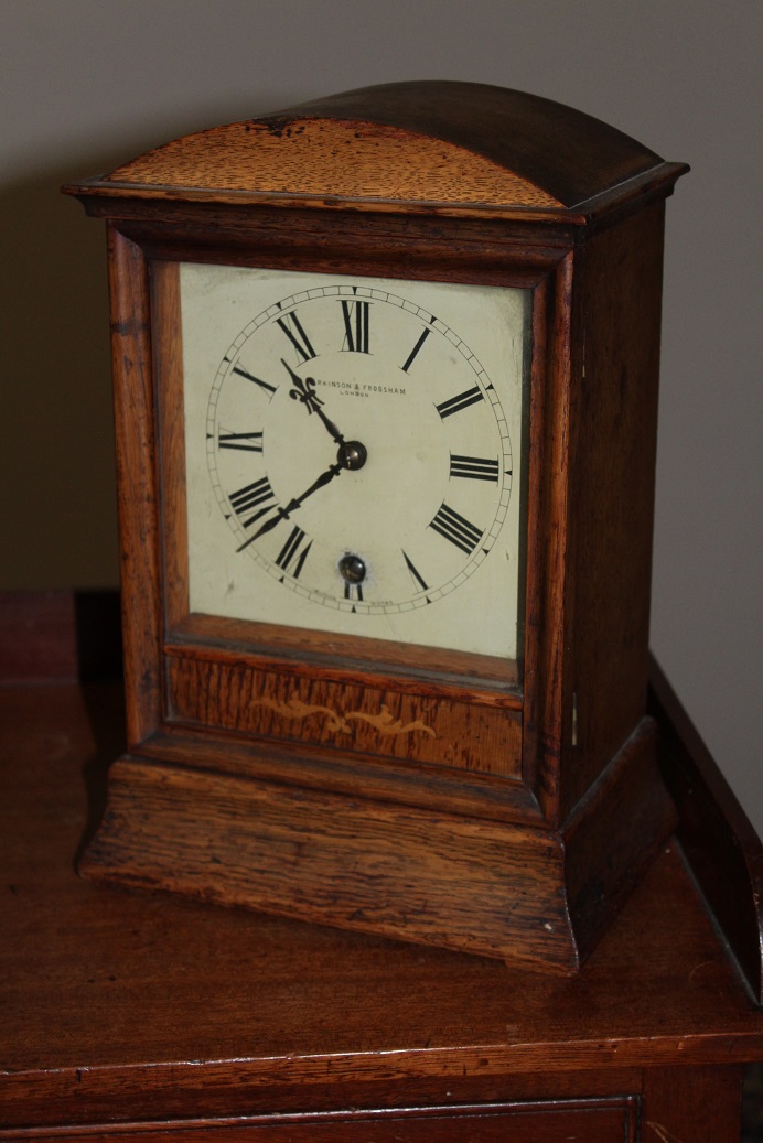 AN OAK FRAMED MANTEL CLOCK, c.1900, by P