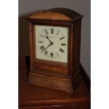 AN OAK FRAMED MANTEL CLOCK, c.1900, by P