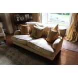 A PAIR OF TWO SEATER HUMP BACK SOFAS on